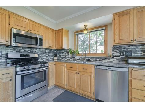 stainless steel appliances with oak cabinets and tile countertops|old oak cabinets.